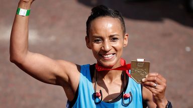 BBC presenter Adele Roberts celebrates with her medal after finishing the London Marathon in 2017